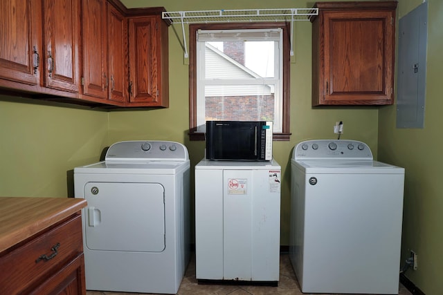 washroom with washer and dryer, electric panel, cabinets, and light tile patterned flooring