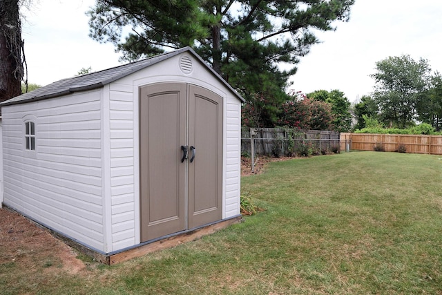 view of shed featuring fence