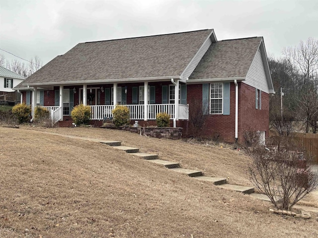 view of front facade with a front yard and a porch