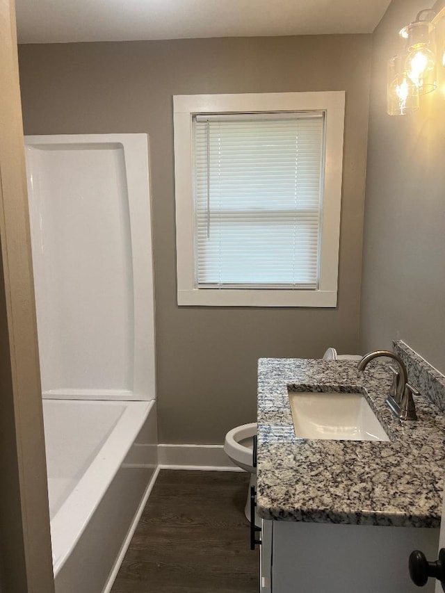  - full bathroom featuring baseboards, toilet, vanity, and wood finished floors