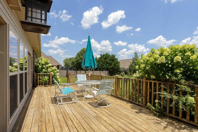  - wooden terrace featuring outdoor dining area
