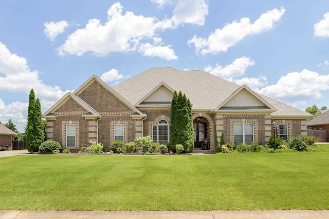  - view of front of property with brick siding and a front lawn