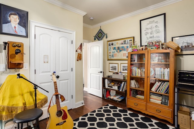  - recreation room featuring crown molding and dark wood finished floors