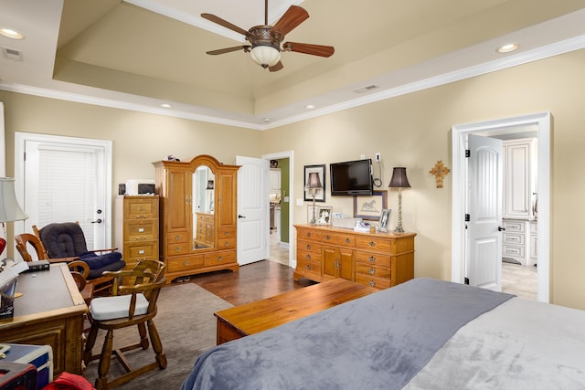  - bedroom with crown molding, a tray ceiling, recessed lighting, and ensuite bathroom