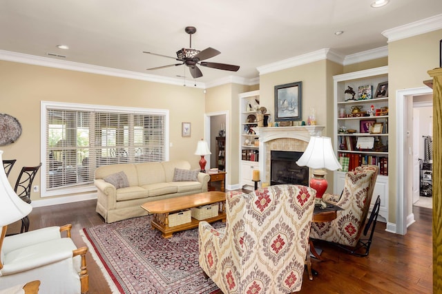  - living room featuring a tile fireplace, ceiling fan, wood finished floors, crown molding, and recessed lighting