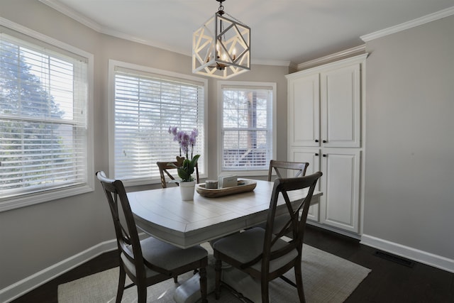 dining space with visible vents, baseboards, dark wood-style floors, crown molding, and a notable chandelier