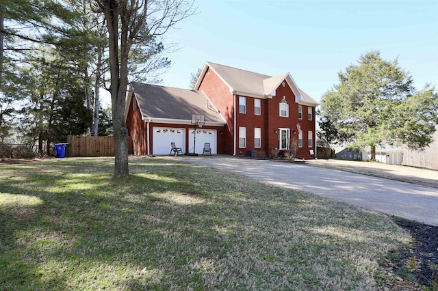 view of front of home with a garage, a front yard, fence, and driveway