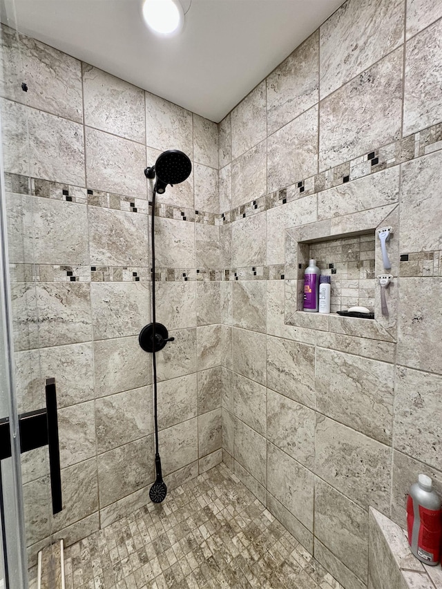 full bathroom with a tile shower