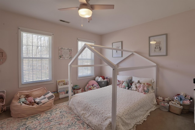 carpeted bedroom featuring ceiling fan and visible vents