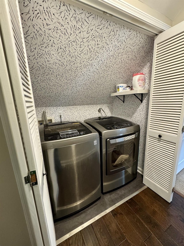 washroom with wallpapered walls, laundry area, baseboards, dark wood-type flooring, and washer and dryer