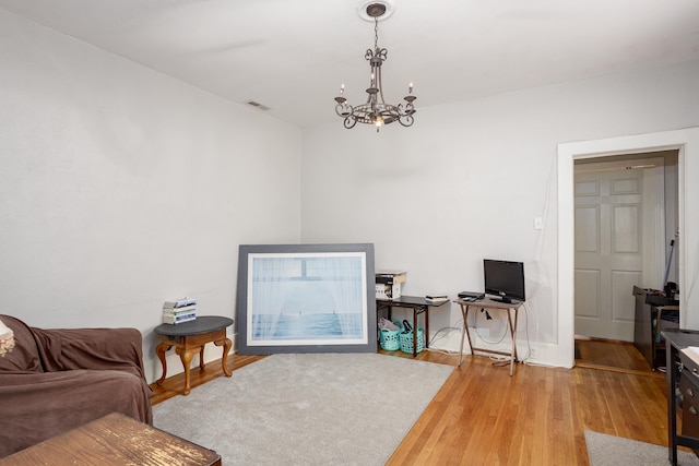  - living room featuring a chandelier and wood finished floors