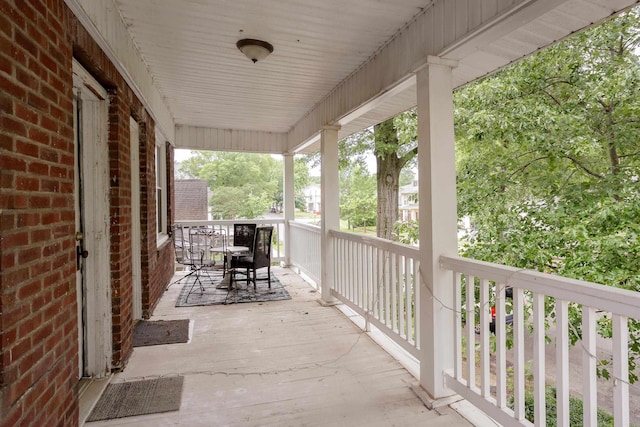  - porch featuring outdoor dining space
