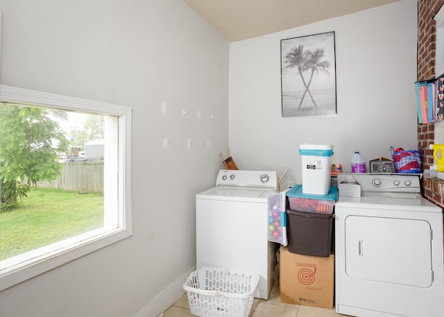  - laundry room with washing machine and dryer and light tile patterned floors