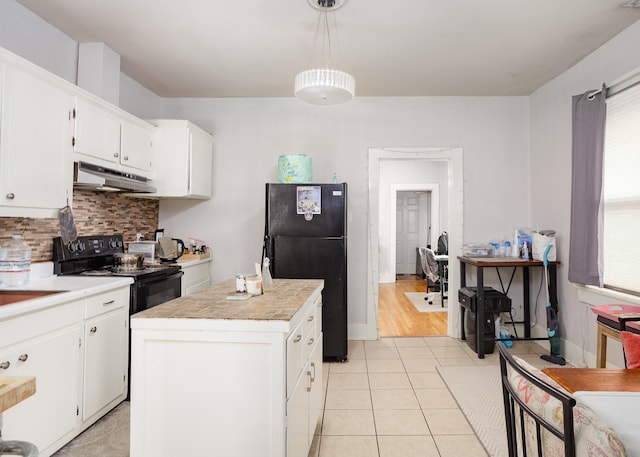  - kitchen with black appliances, under cabinet range hood, backsplash, and white cabinetry