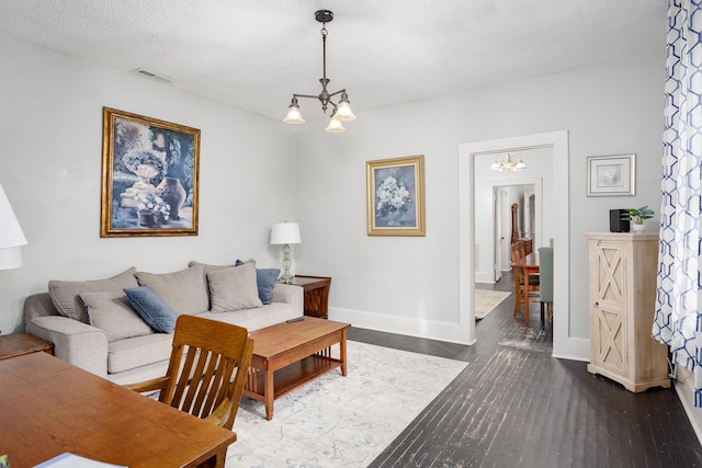  - living room with a chandelier and dark wood-style floors