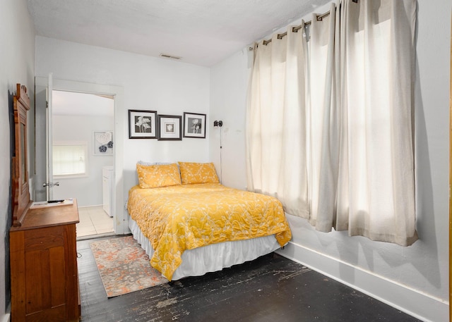  - bedroom featuring baseboards and wood finished floors