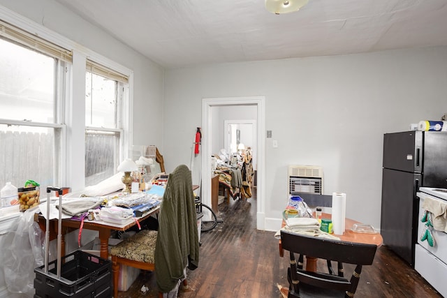  - dining space with wood finished floors and heating unit