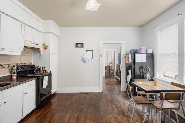  - kitchen with black range with electric cooktop, under cabinet range hood, dark wood finished floors, dark countertops, and backsplash