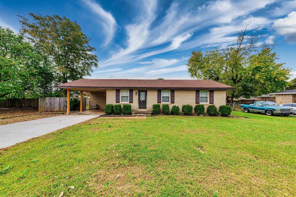 single story home featuring a front yard and a carport