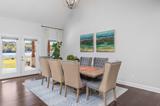 dining area featuring a chandelier, french doors, high vaulted ceiling, and dark wood-type flooring