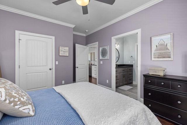 bedroom featuring connected bathroom, dark hardwood / wood-style floors, ceiling fan, and ornamental molding