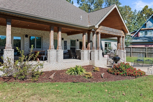 exterior space with covered porch and a yard