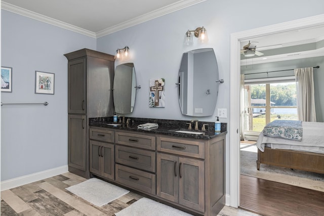 bathroom with ceiling fan, hardwood / wood-style floors, vanity, and ornamental molding