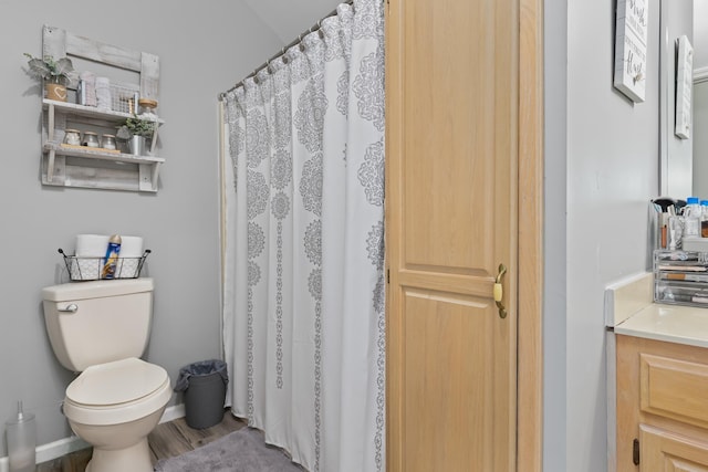 bathroom with wood-type flooring, vanity, toilet, and a shower with curtain