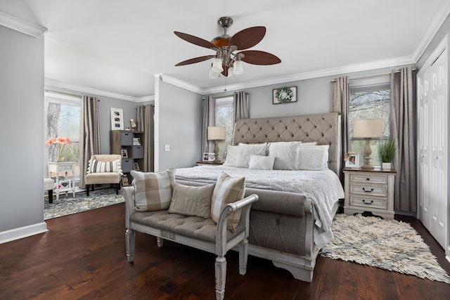 bedroom with ceiling fan, dark hardwood / wood-style flooring, and multiple windows