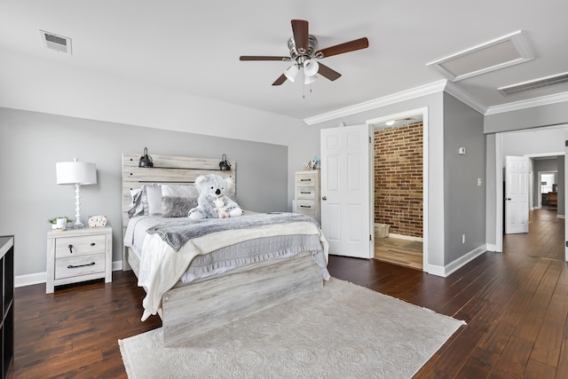 bedroom with crown molding, ceiling fan, dark hardwood / wood-style floors, connected bathroom, and brick wall