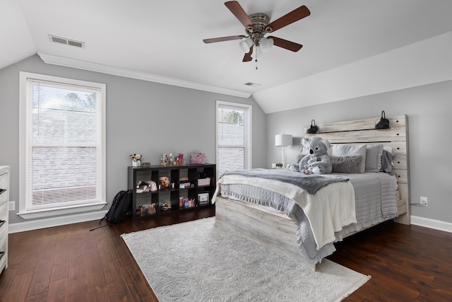 bedroom featuring ceiling fan, dark hardwood / wood-style flooring, ornamental molding, and vaulted ceiling