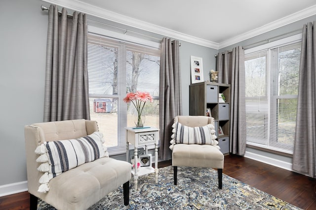 sitting room with dark hardwood / wood-style flooring and crown molding