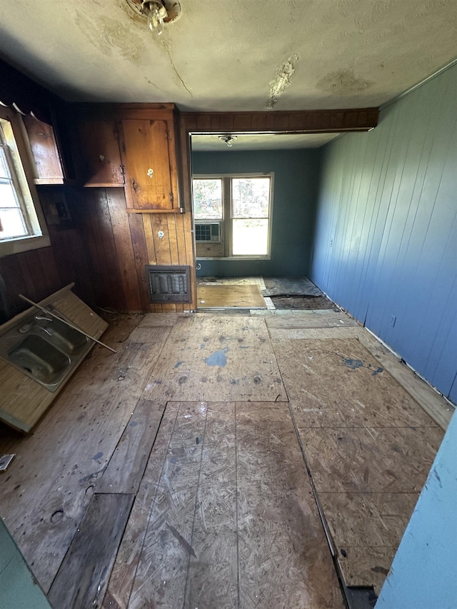 miscellaneous room featuring beamed ceiling, cooling unit, and wood walls