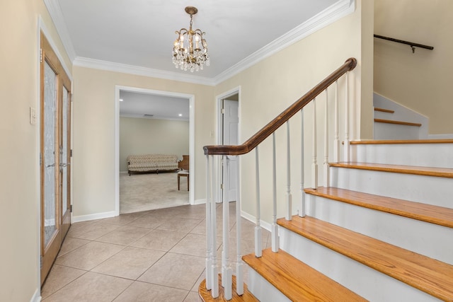 foyer with ornamental molding, light tile patterned floors, and a notable chandelier