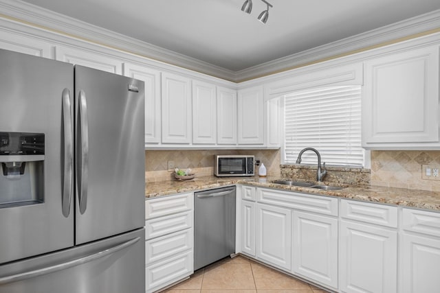 kitchen with sink, light tile patterned floors, white cabinets, and appliances with stainless steel finishes