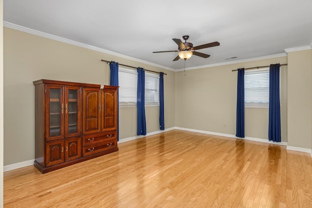 empty room with crown molding, ceiling fan, and light hardwood / wood-style floors