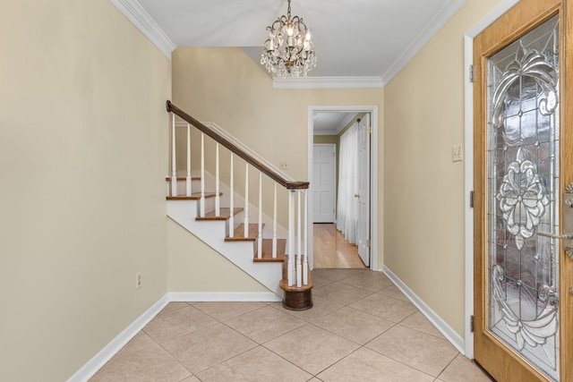 tiled entrance foyer with ornamental molding and a chandelier