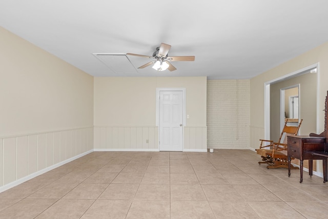 unfurnished room with ceiling fan and light tile patterned floors