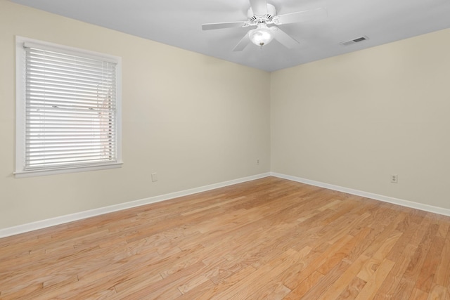 empty room featuring ceiling fan and light hardwood / wood-style floors