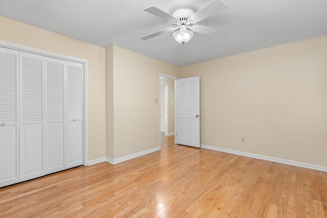 unfurnished bedroom with ceiling fan, light wood-type flooring, and a closet