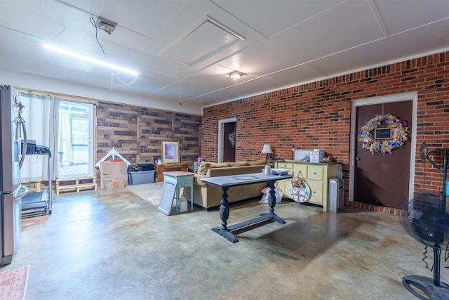  - rec room featuring concrete flooring and brick wall