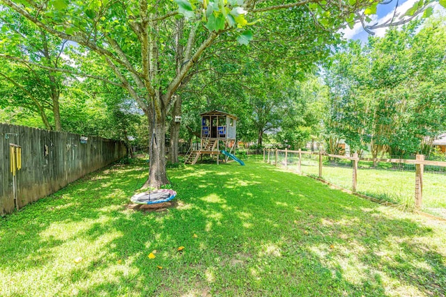  - fenced backyard with a playground