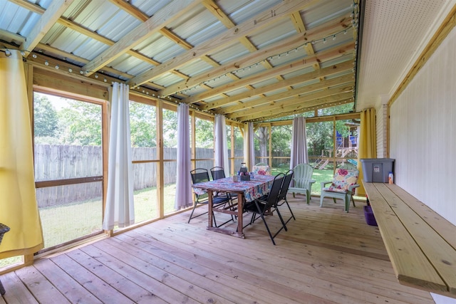  - sunroom with a deck, outdoor dining area, and hardwood / wood-style flooring