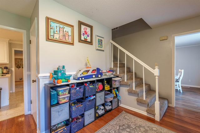  - staircase featuring wood finished floors