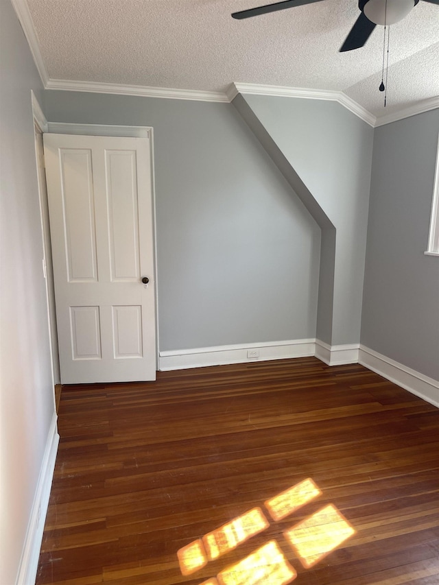 bonus room with ceiling fan, dark hardwood / wood-style floors, a textured ceiling, and vaulted ceiling