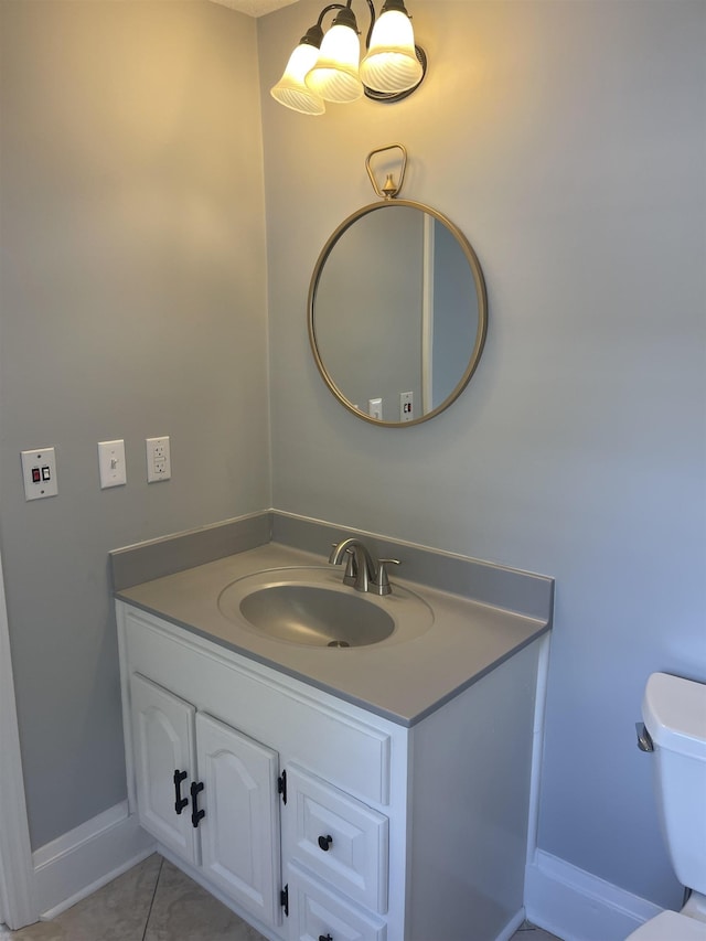 bathroom with tile patterned flooring, vanity, and toilet