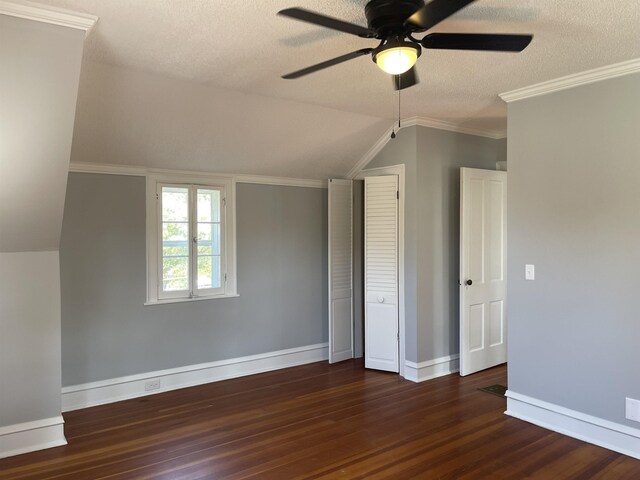 bonus room featuring dark hardwood / wood-style floors, ceiling fan, a textured ceiling, and vaulted ceiling