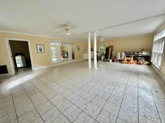 unfurnished living room with ornate columns, crown molding, ceiling fan, and light tile patterned flooring