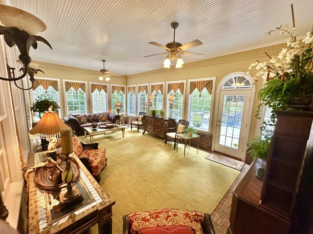 carpeted living room with ceiling fan