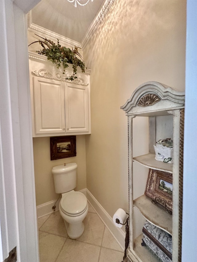 bathroom featuring tile patterned flooring, toilet, and crown molding